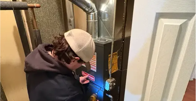 HVAC technician working on ductwork