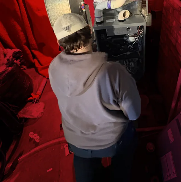 HVAC technician performing seasonal maintenance